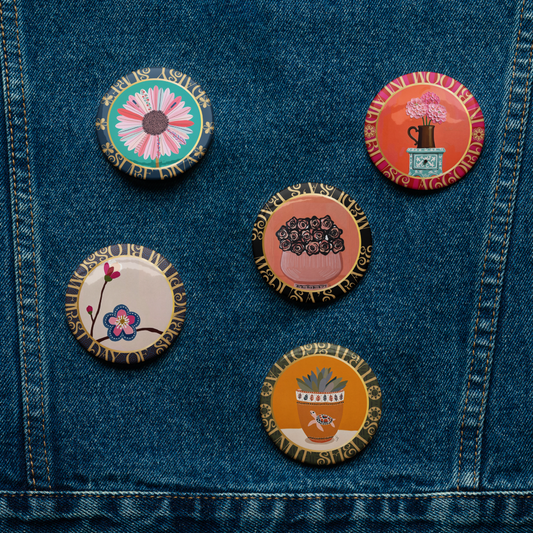 Set of colorful pins on a denim jacket-Five-piece floral medallion art pin set including daisy hydrangea plum blossom rose bouquet and potted succulent pinback buttons by Szeto on a white background
