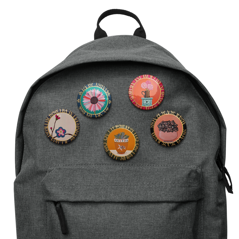 Gray backpack with colorful patches on a white background from theFive-piece floral medallion art pin set including daisy hydrangea plum blossom rose bouquet and potted succulent pinback buttons by Szeto 